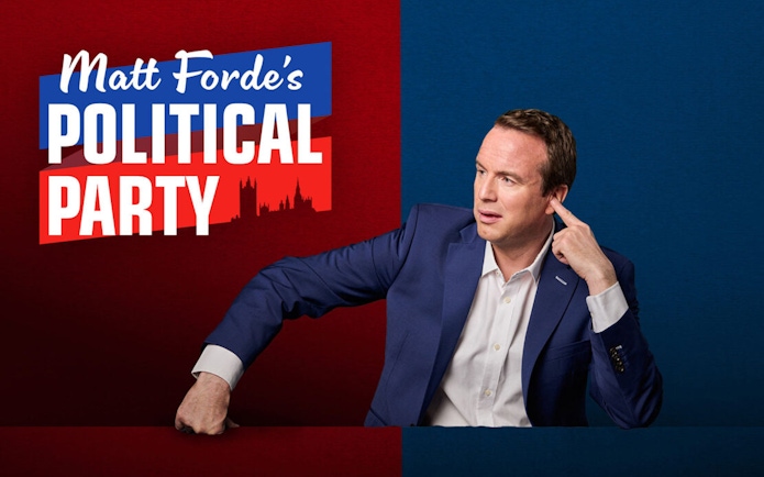 Matt Ford gesturing on stage for The Political Party show backdrop