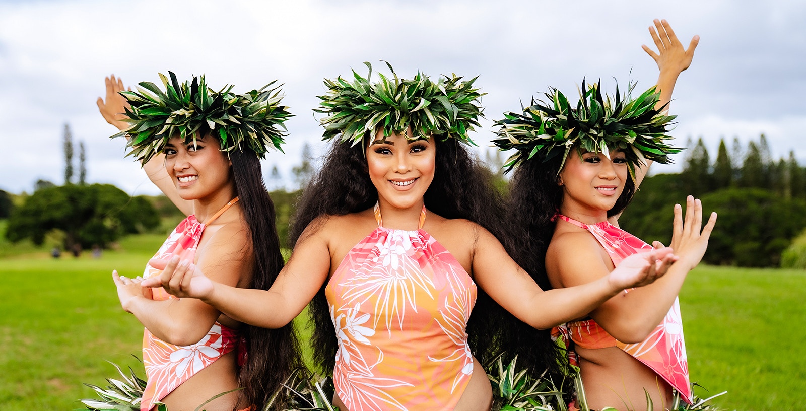 Dancers performing at Mauka Warriors Luau in traditional attire with leaf crowns.