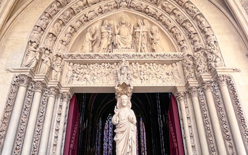 Sculpted entrance of Sainte Chapelle with intricate religious carvings, Paris.