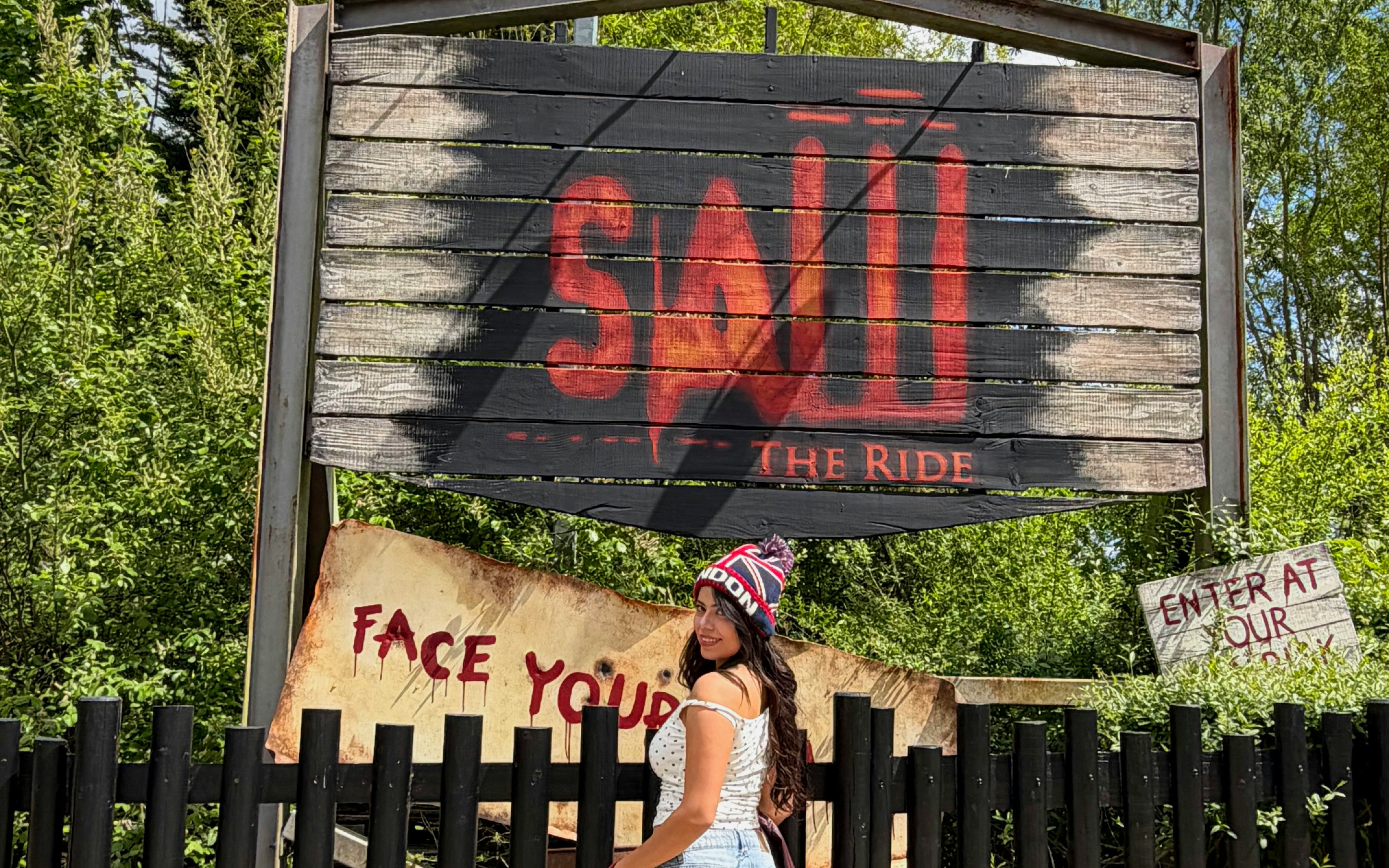 Saw The Ride entrance at Thorpe Park with visitor nearby.