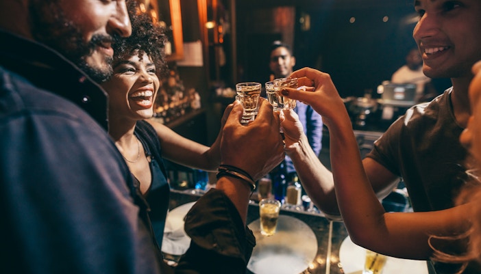 Group enjoying drinks at a lively bar