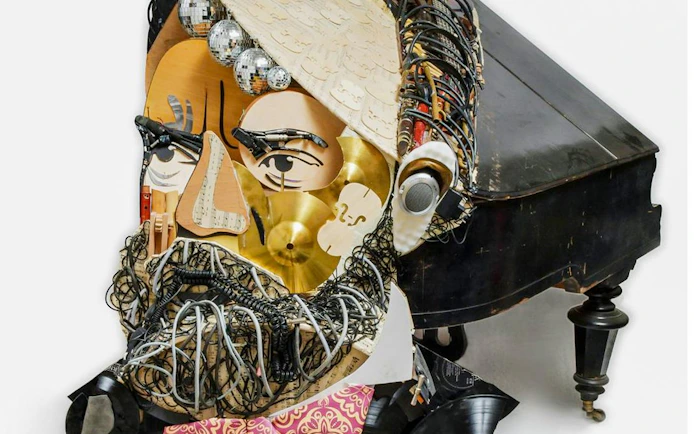 Collage sculpture of a face made from musical instruments at IAM Illusion Art Museum, Prague.