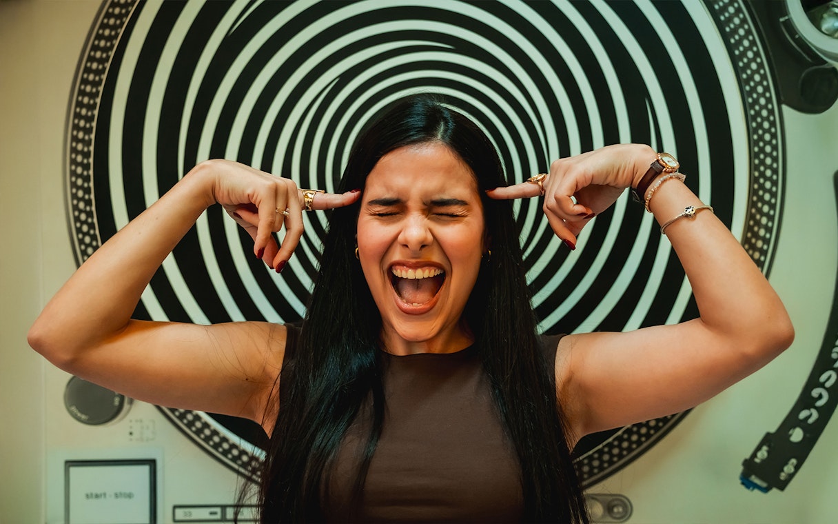 Visitor interacting with optical illusion exhibit at the Museum of Illusions, Madrid.