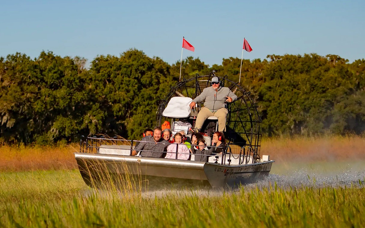 Guests on an airboat ride during Boggy Creek 1 Hour Sunset Airboat Tour.