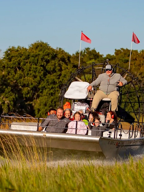 Guests on an airboat ride during Boggy Creek 1 Hour Sunset Airboat Tour.