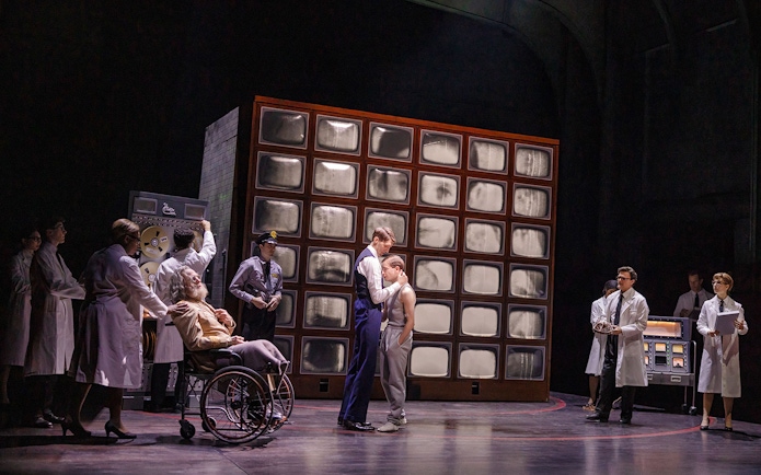 Scientists and guards in a lab with a wall of screens, related to Stranger Things.