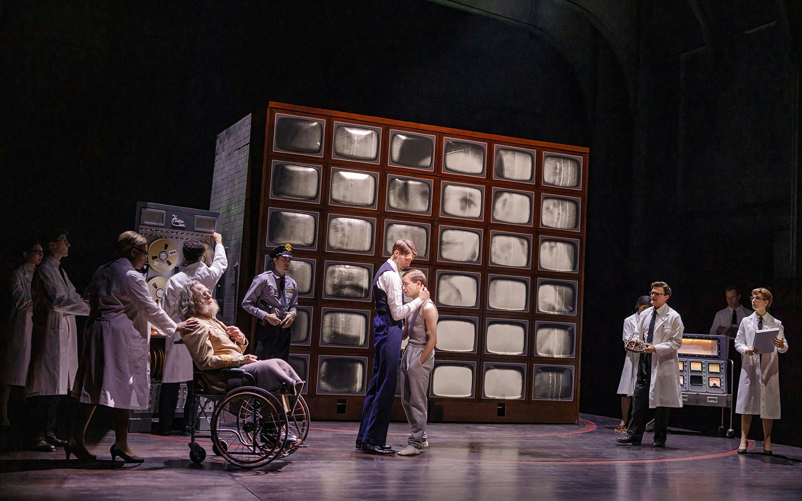 Scientists and guards in a lab with a wall of screens, related to Stranger Things.