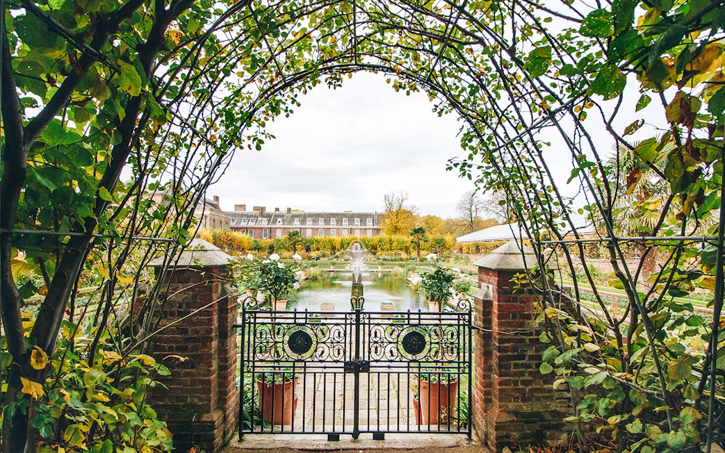 Kensington Palace gardens view through ornate gate, London.