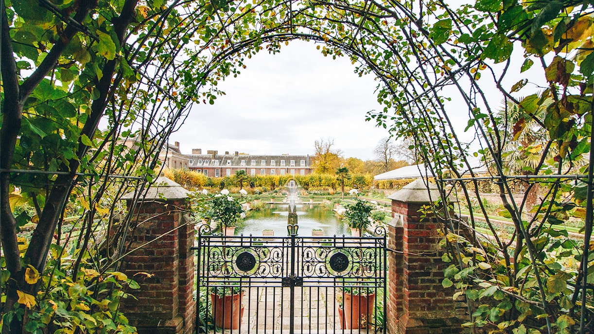 Kensington Palace gardens view through ornate gate, London.