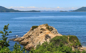 Rocky coastline of Yashima, Takamatsu City, Kagawa Prefecture, Japan, with distant islands.