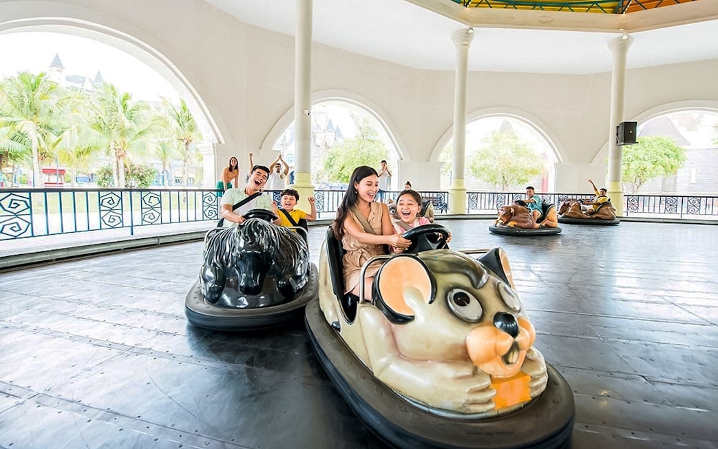 People enjoying bumper car rides at an amusement park.