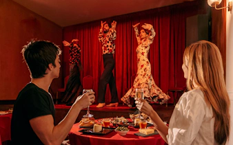 Flamenco dancers performing on stage at Laietana, Barcelona, with audience dining.