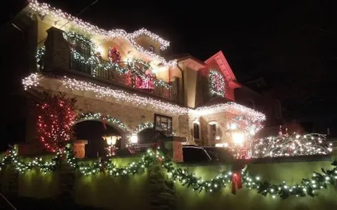 Dyker Heights house adorned with Christmas lights during guided tour, New York.
