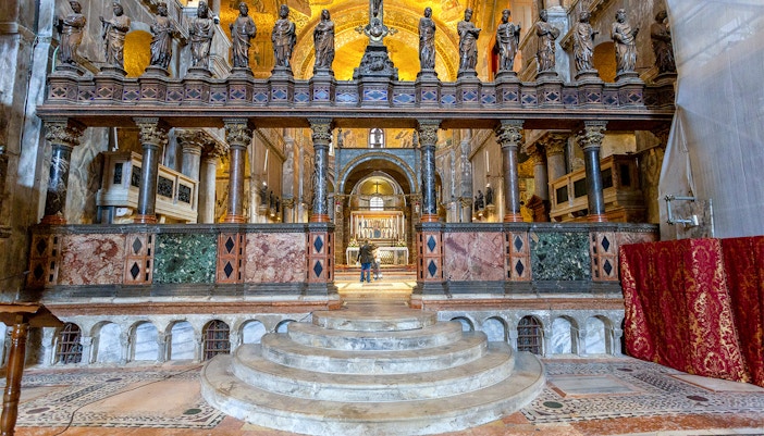 St. Mark's Basilica exterior with ornate domes and arches in Venice, Italy.
