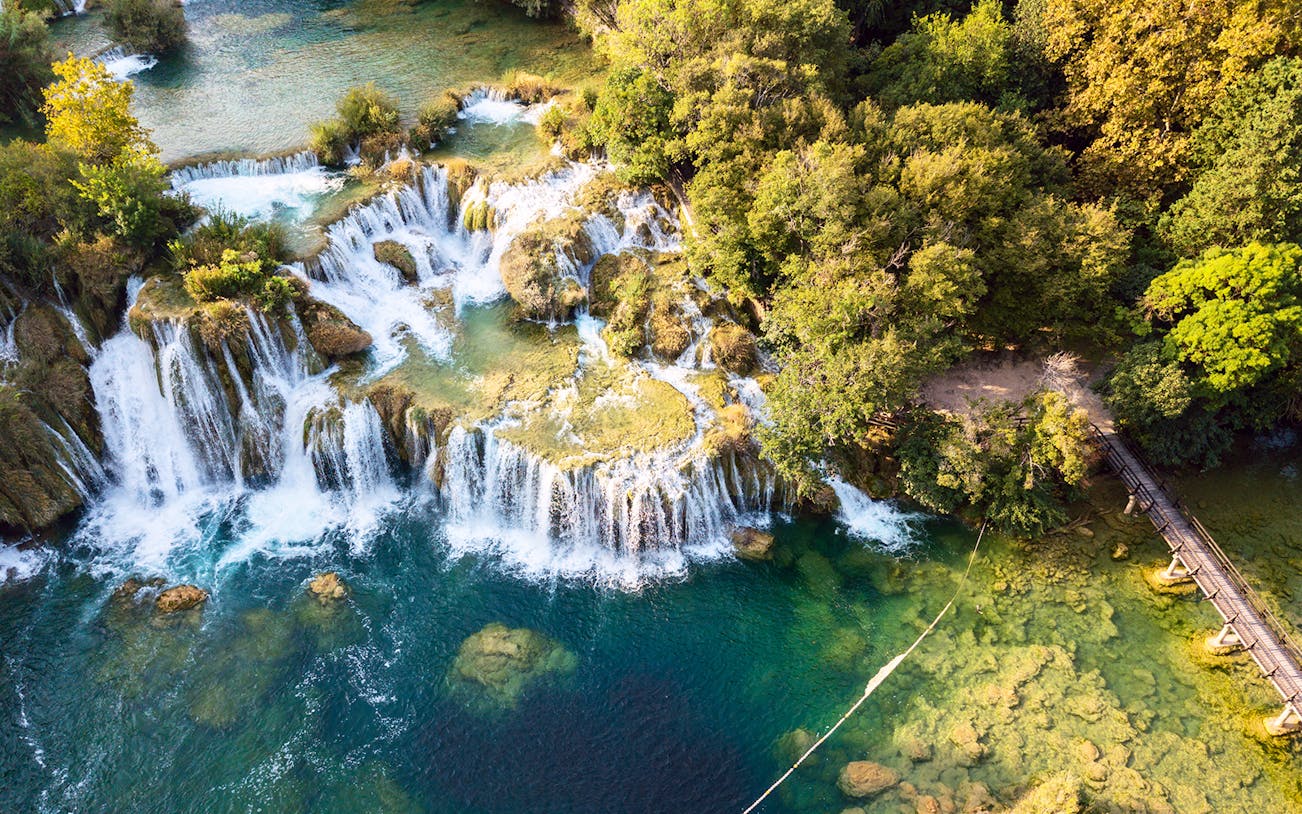 Waterfalls and wooden bridge at Krka National Park, Croatia.