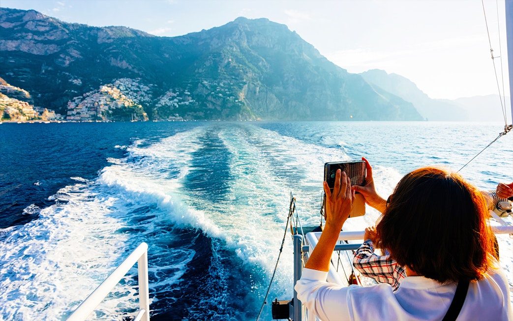 Private boat tour on Amalfi Coast from Positano with view of cliffs and sea.