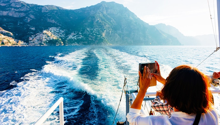 Private boat tour on Amalfi Coast from Positano with view of cliffs and sea.