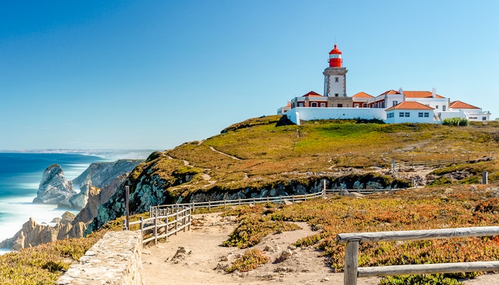 Cabo da Roca lighthouse on a cliff overlooking the Atlantic Ocean in Portugal.