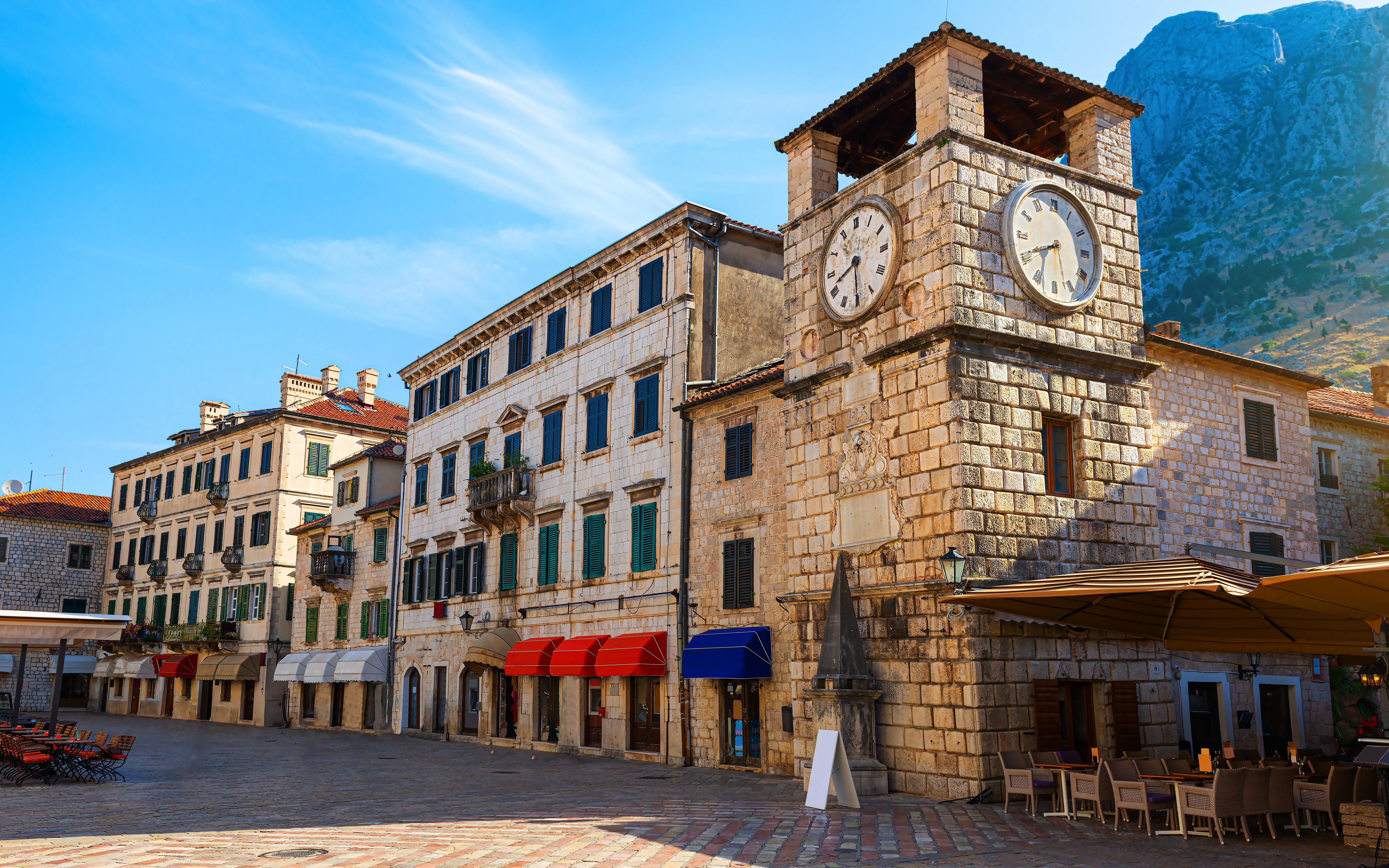 Clock Tower in Arms Square, Kotor Old Town, with surrounding historic buildings.