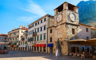 Clock Tower in Arms Square, Kotor Old Town, with surrounding historic buildings.