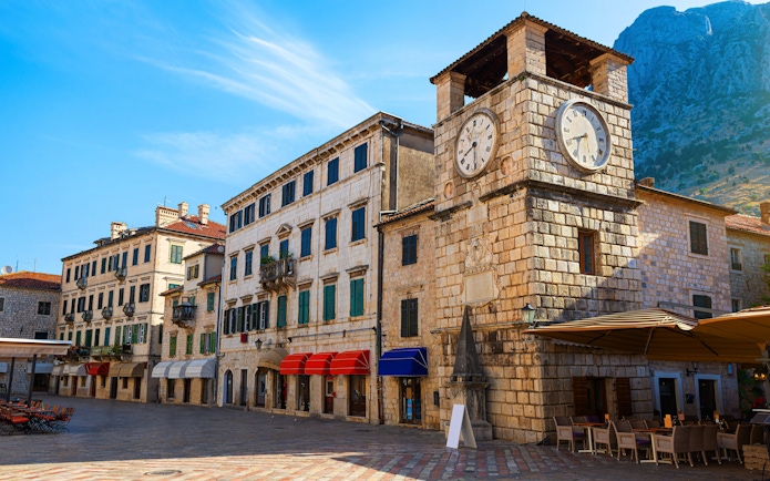 Clock Tower in Arms Square, Kotor Old Town, with surrounding historic buildings.