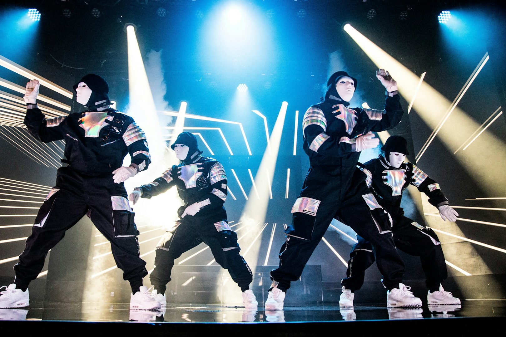 Dancers performing at Jabbawockeez show in Las Vegas with dynamic lighting effects.