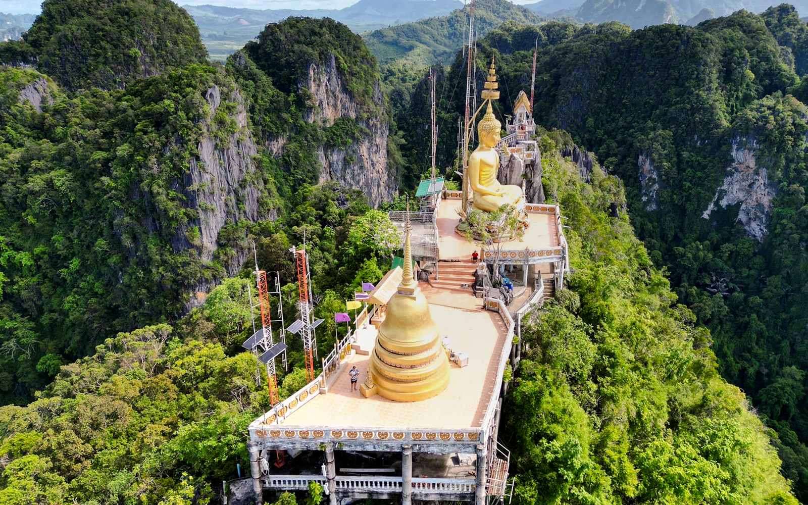 Aerial view of Tiger Cave Temple with golden Buddha statue in Krabi, Thailand.