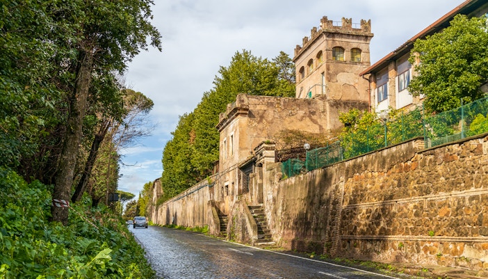 Tourists exploring Roman basilicas and catacombs on the Appian Way, Rome, Italy.