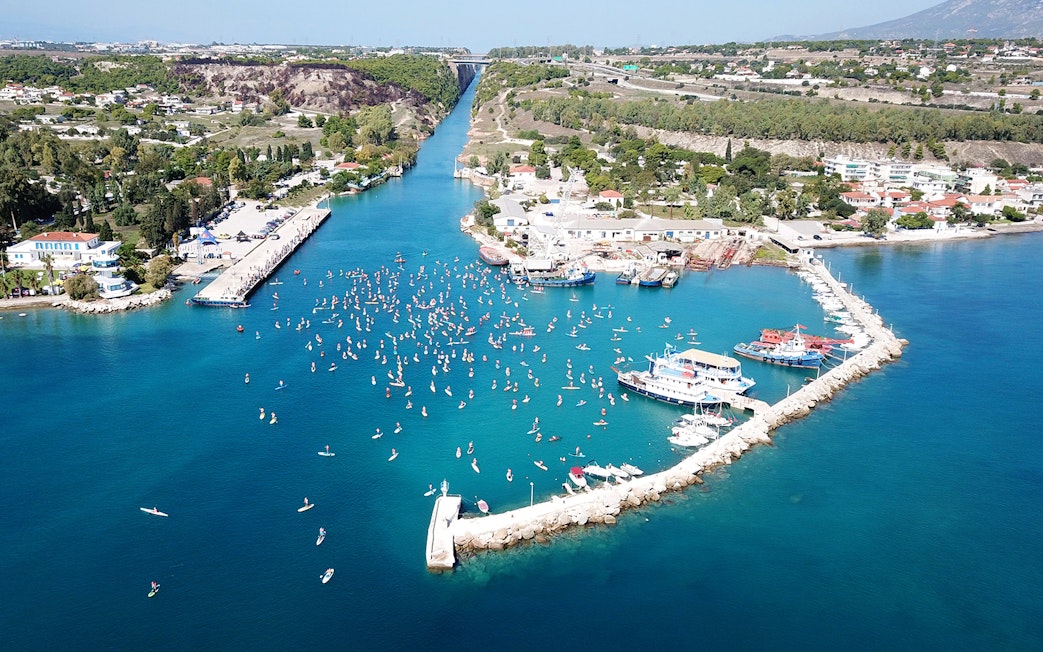 Aerial view of Corinth Canal with boats and paddleboarders, part of Nafplio-Mycenae-Epidaurus Day Tour.