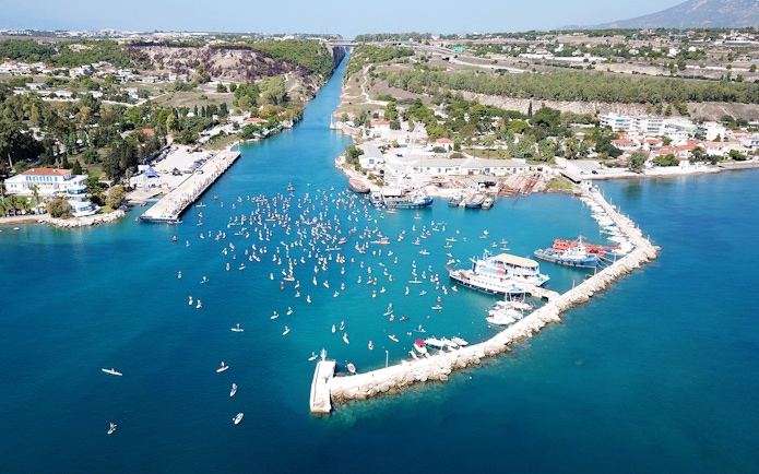 Aerial view of Corinth Canal with boats and paddleboarders, part of Nafplio-Mycenae-Epidaurus Day Tour.
