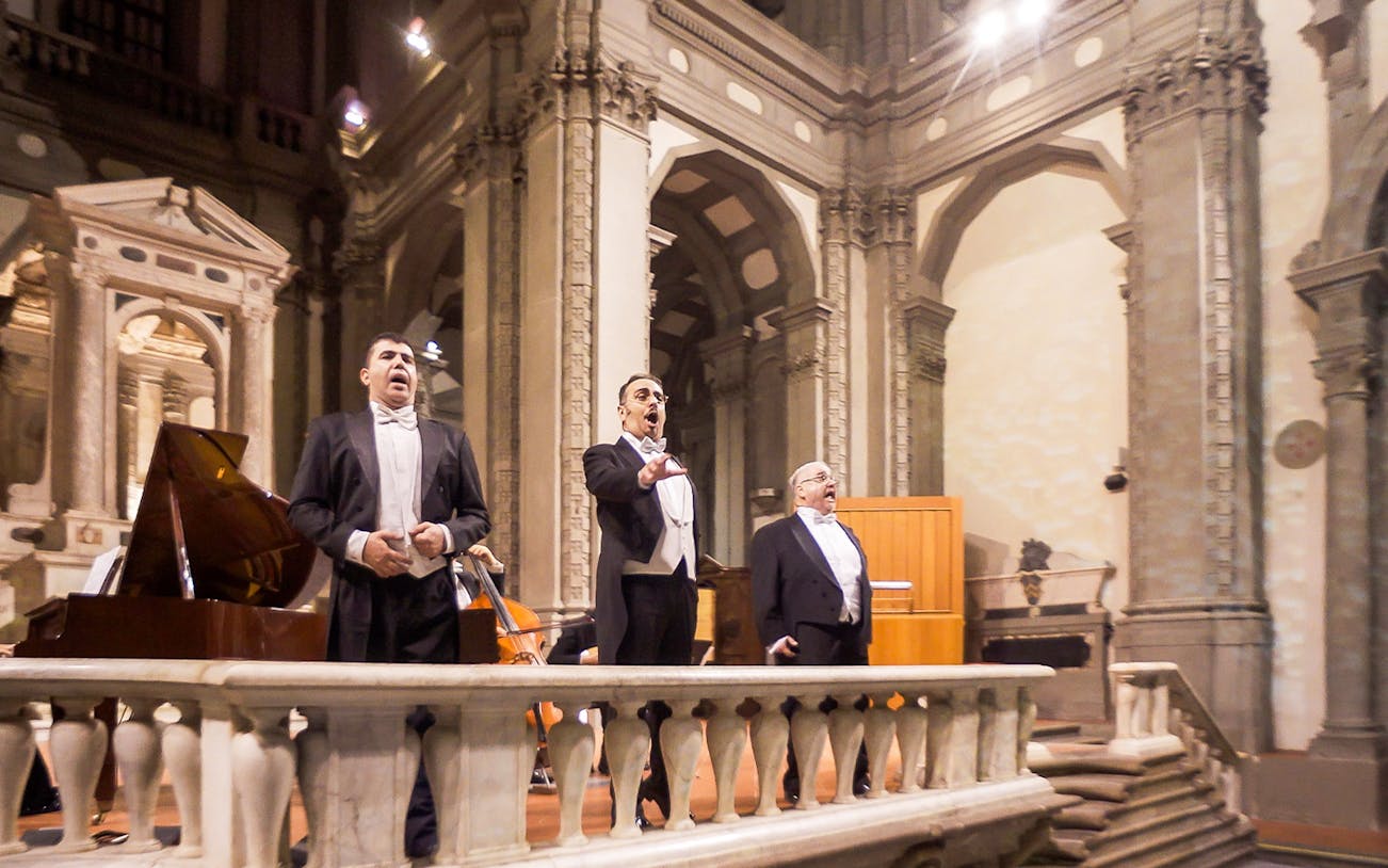 Three tenors performing in a historic Florence venue during a Tuscan dinner concert.