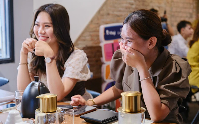 Participants enjoying a Vietnamese coffee workshop, engaging in cultural discovery.