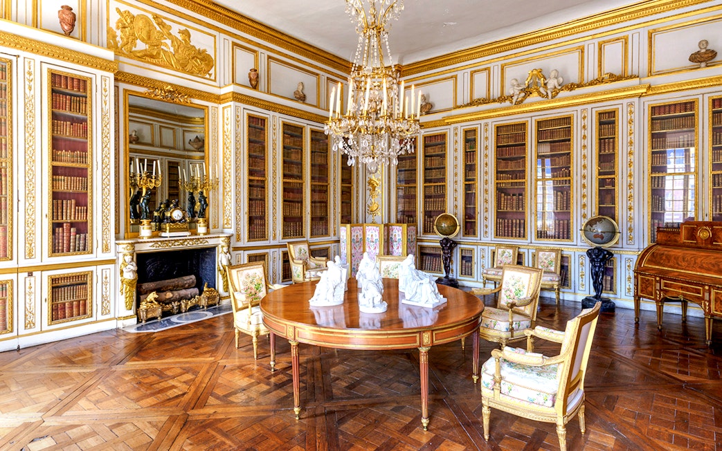 Versailles Palace King's Private Apartments library with ornate decor and chandelier.