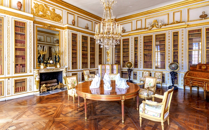 Versailles Palace King's Private Apartments library with ornate decor and chandelier.