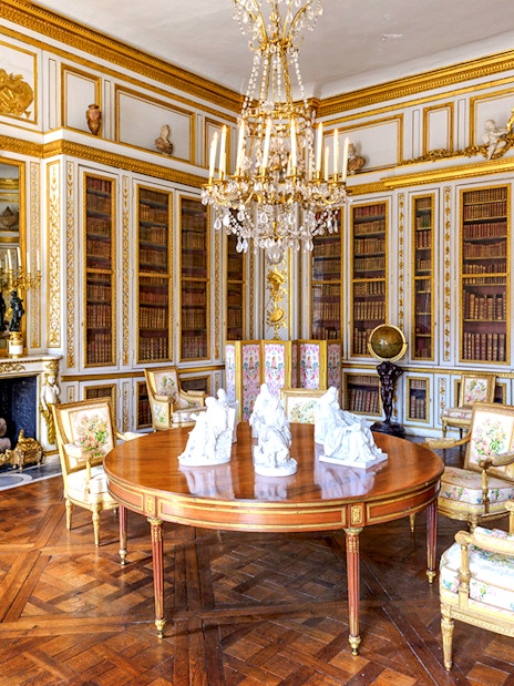 Versailles Palace King's Private Apartments library with ornate decor and chandelier.