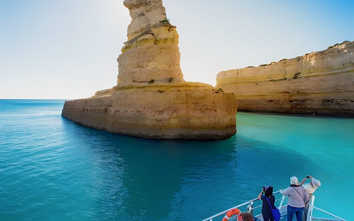 Tourists on a boat near Benagil Caves, Algarve, Portugal.