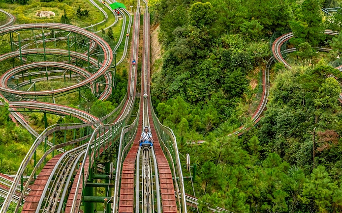 Alpine Coaster winding through lush forest at Ba Na Hills, Da Nang, Vietnam.