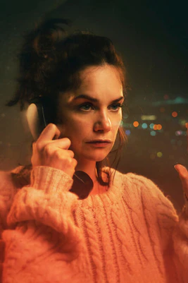 Woman on phone with city lights in background, promoting "The Human Voice" by Jean Cocteau.