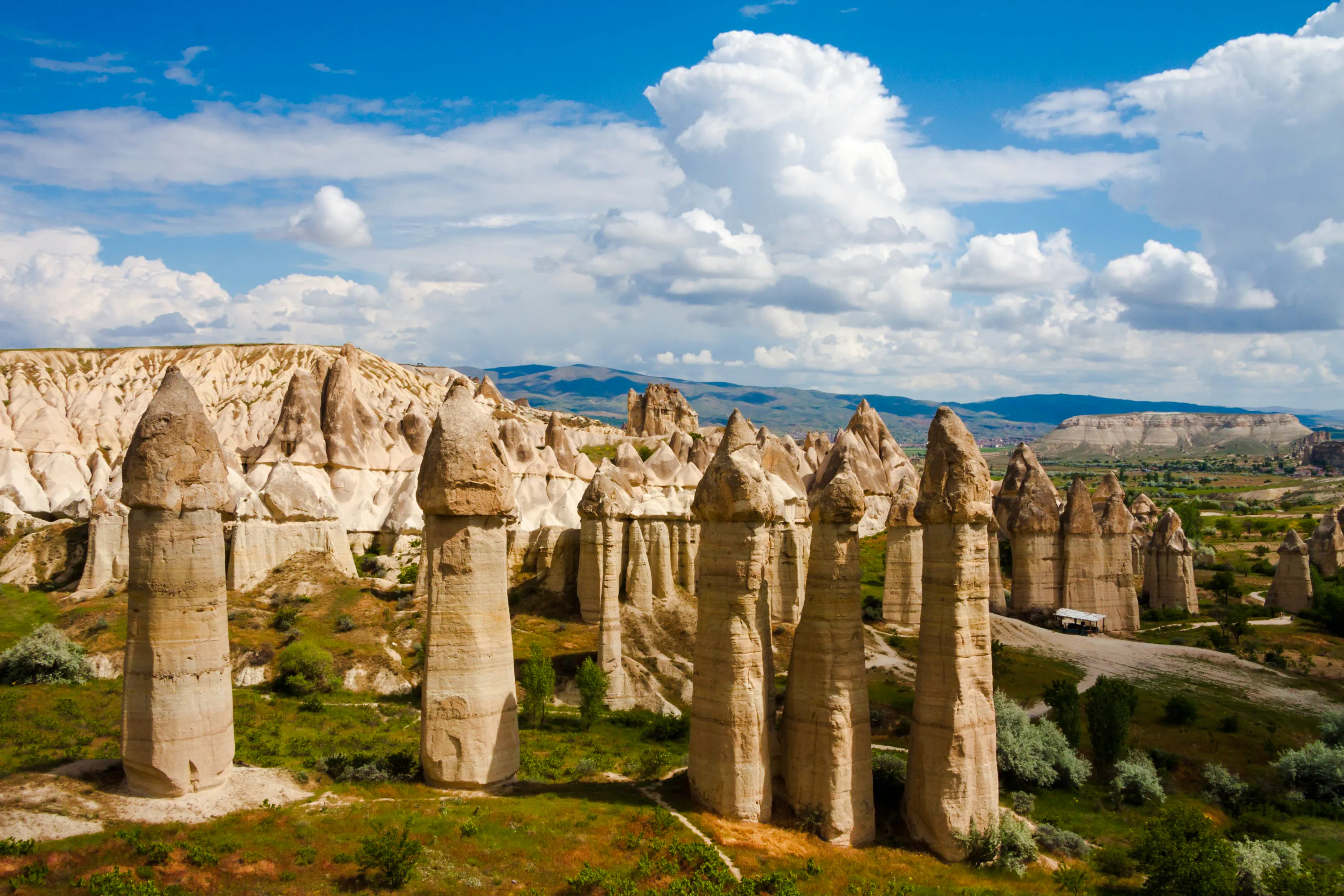 Fairy chimneys in Cappadocia, Turkey, under a blue sky, part of the Cappadocia Mix Tour.
