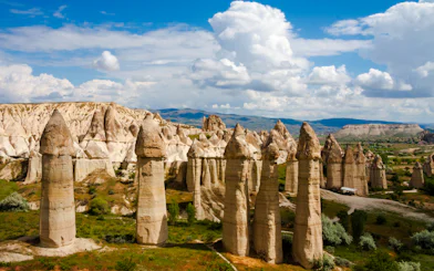 Fairy chimneys in Cappadocia, Turkey, under a blue sky, part of the Cappadocia Mix Tour.