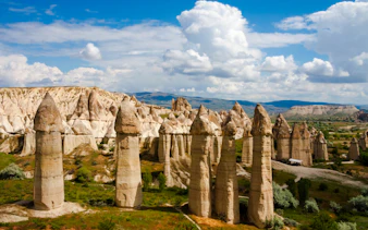 Fairy chimneys in Cappadocia, Turkey, under a blue sky, part of the Cappadocia Mix Tour.