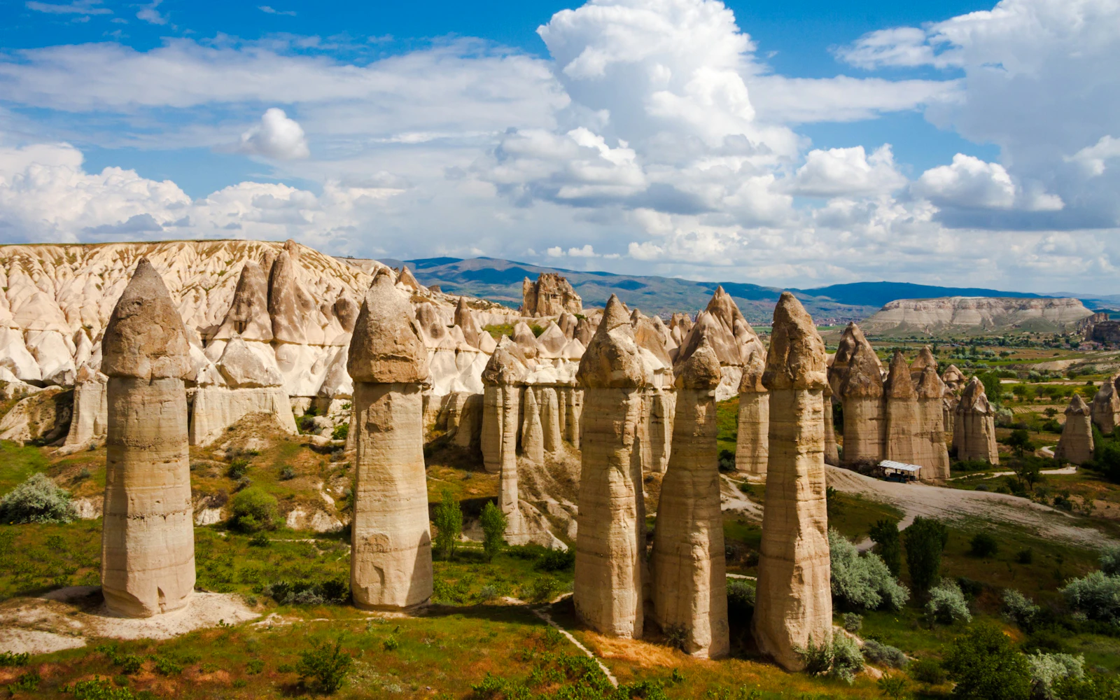 Fairy chimneys in Cappadocia, Turkey, under a blue sky, part of the Cappadocia Mix Tour.