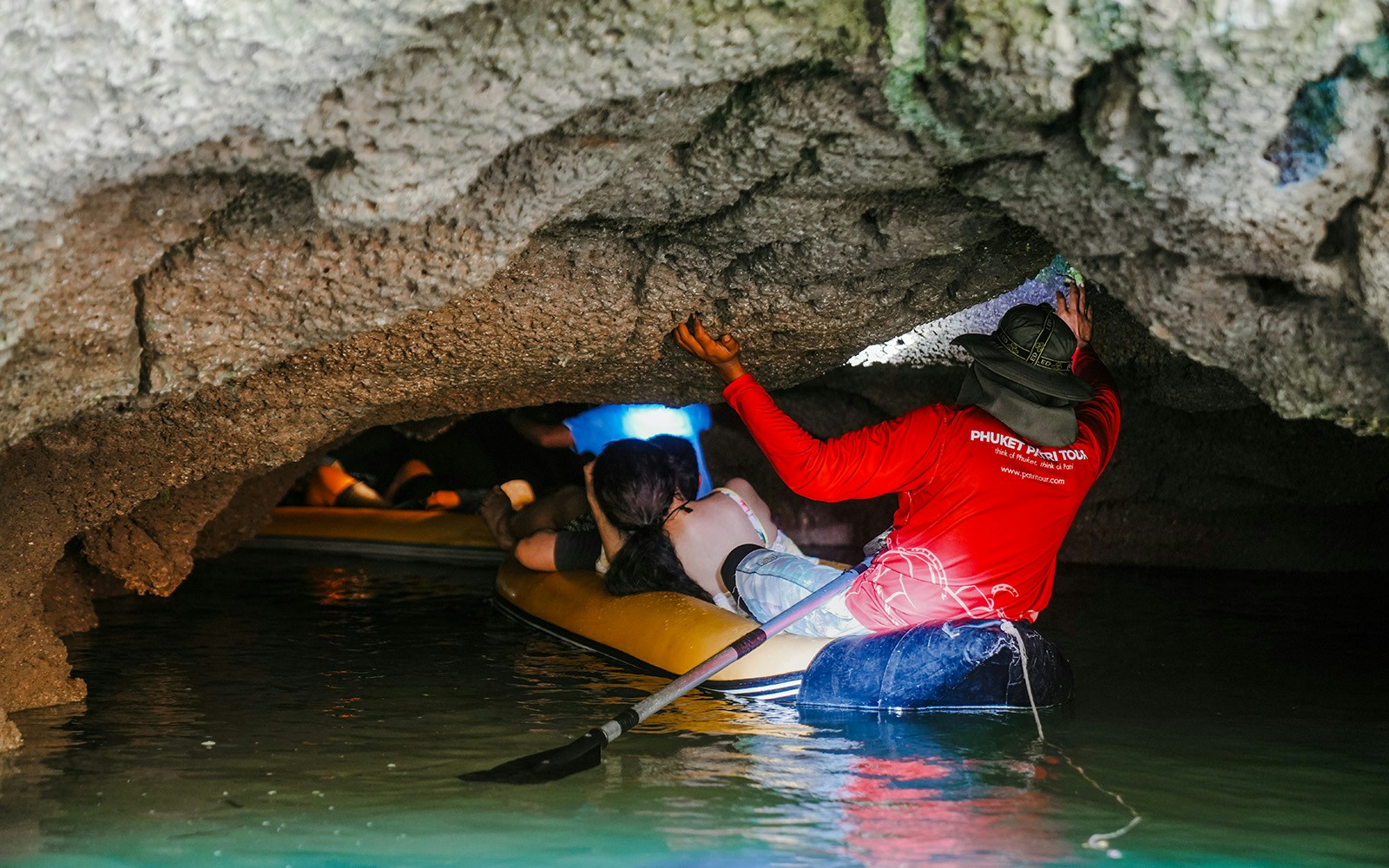 Canoeing through limestone caves at Hong Island, Thailand.