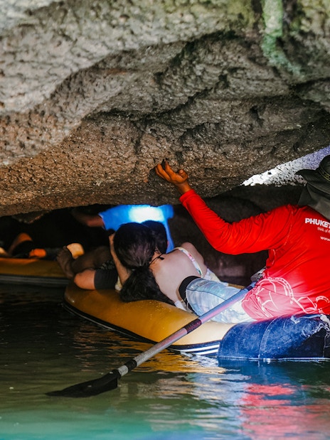 Canoeing through limestone caves at Hong Island, Thailand.