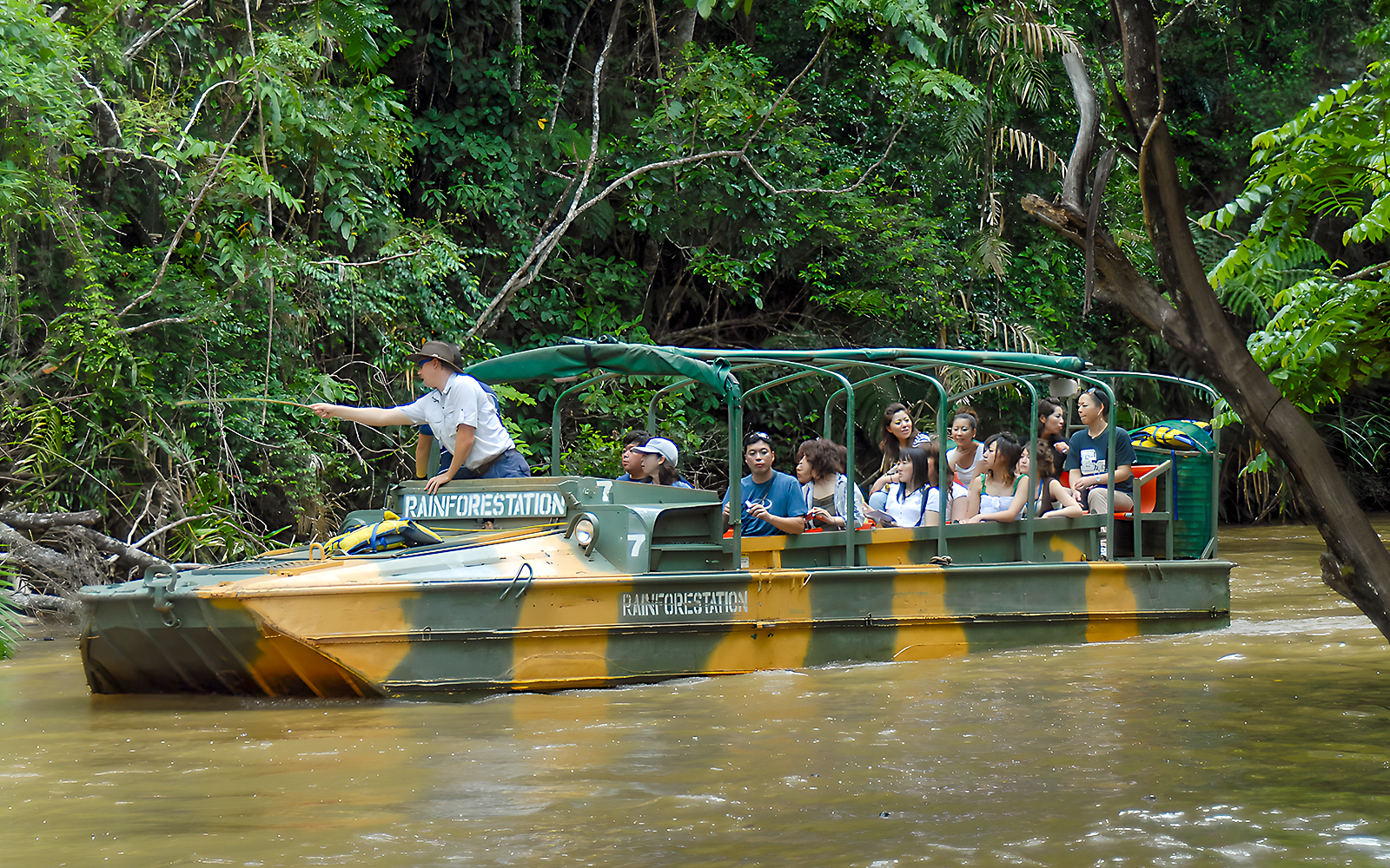 Tourists on an Army Duck boat exploring Kuranda waterways, Queensland rainforest.