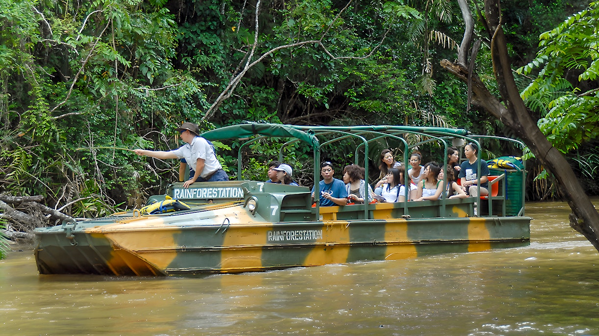 Tourists on an Army Duck boat exploring Kuranda waterways, Queensland rainforest.