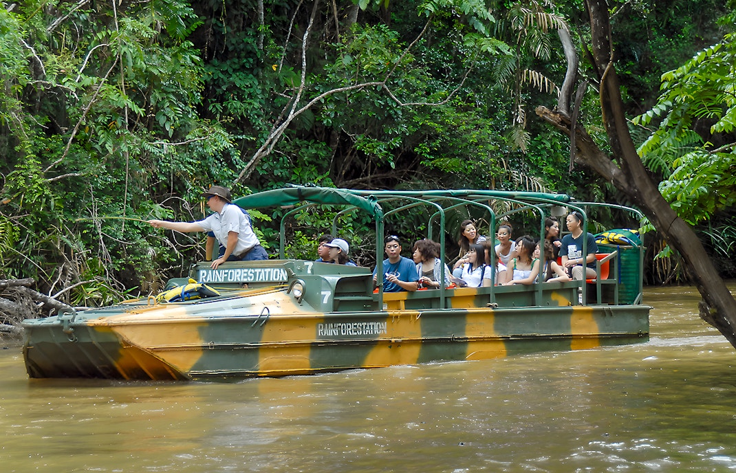 Tourists on an Army Duck boat exploring Kuranda waterways, Queensland rainforest.