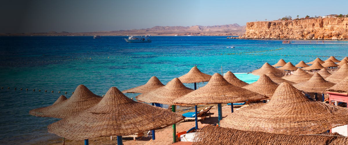 Beach umbrellas and Red Sea view in Sharm el-Sheikh, Egypt.