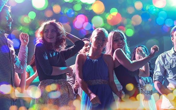 People dancing at PICCADILLY UMEDA Osaka nightclub with colorful lights.