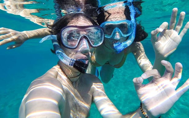 Snorkelers exploring underwater coves in Bosa, Sardinia.